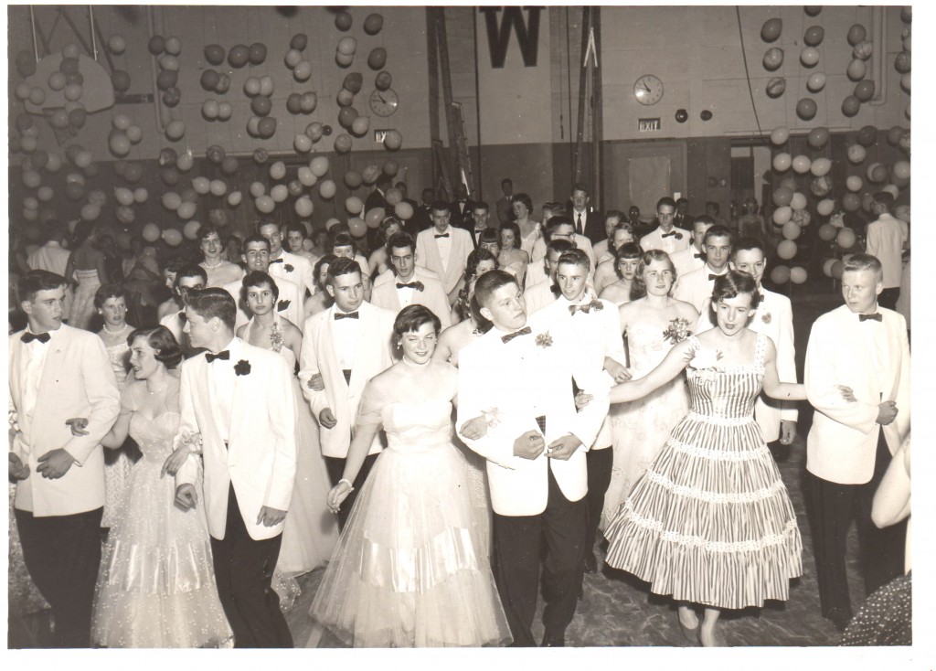 1950s vintage photo of a High school prom or high school dance featuring 1950s prom dresses and 1950s prom outfits. 