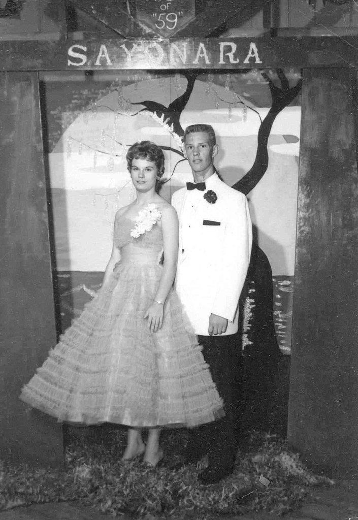 1959 prom couple photo booth image. Pretty 1950s prom dress on display in this vintage image. 