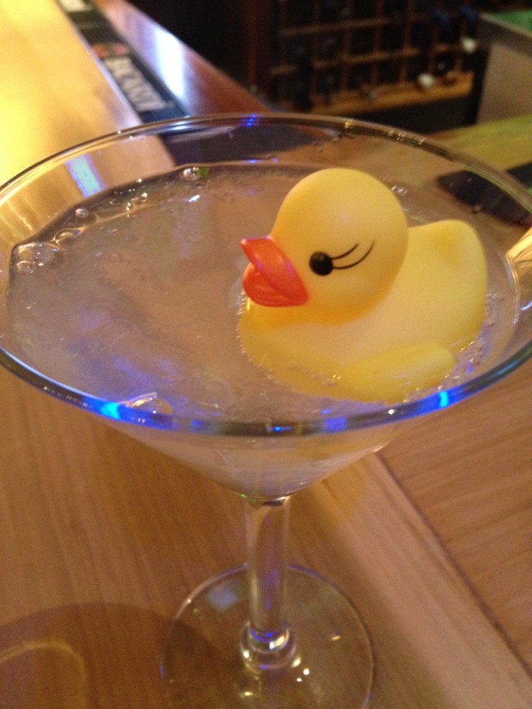 martini drink with a rubber duck in it. 