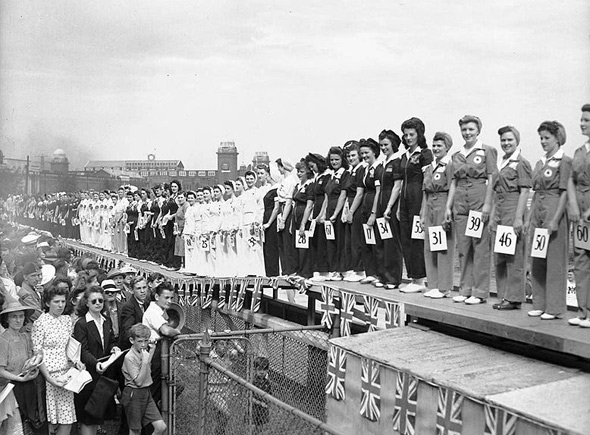 1940s vintage photo of the Canadian Miss War Worker Pageant in 1942. The image features women wearing their factory uniforms. 