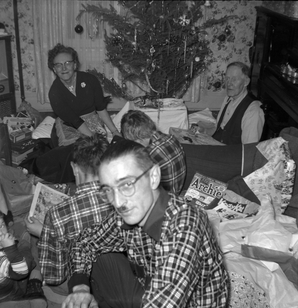 1950s vintage photo: Family in Toronto unwrapping their Christmas presents in 1953 (notice the vintage Archies and Krazy Kat comics?
