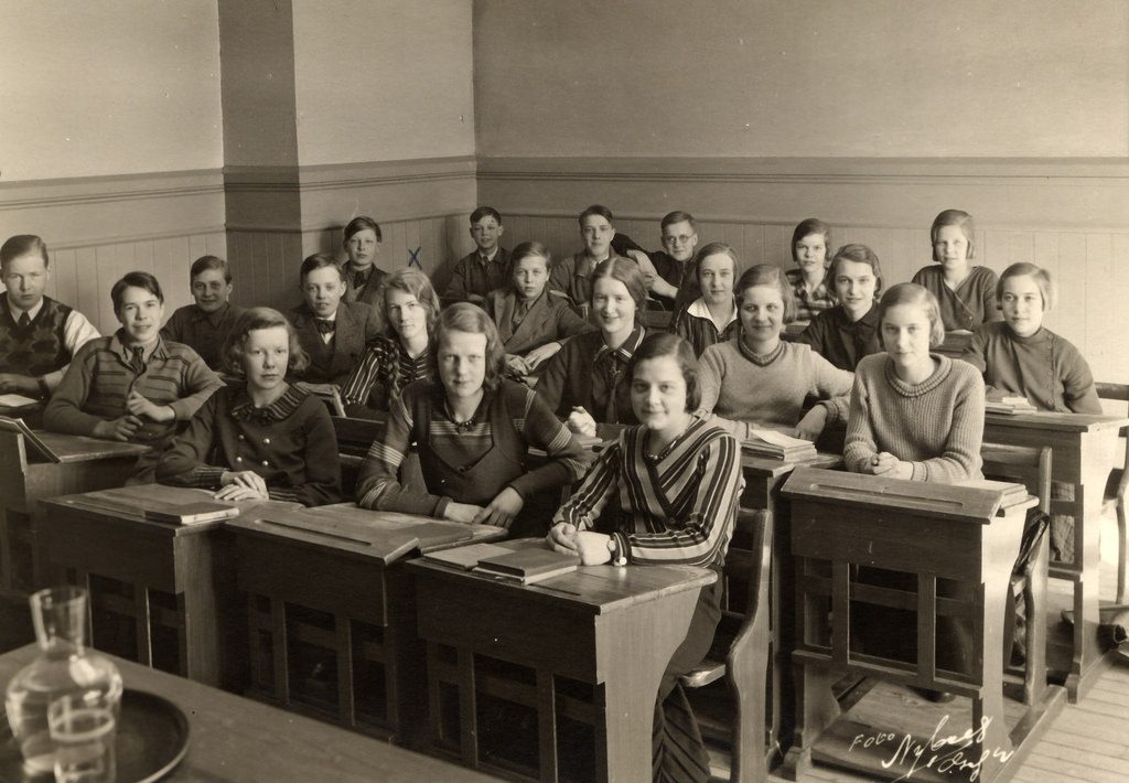 1930s vintage photo of young boys and girls in school posing for a photo in 1930s junior fashions. 