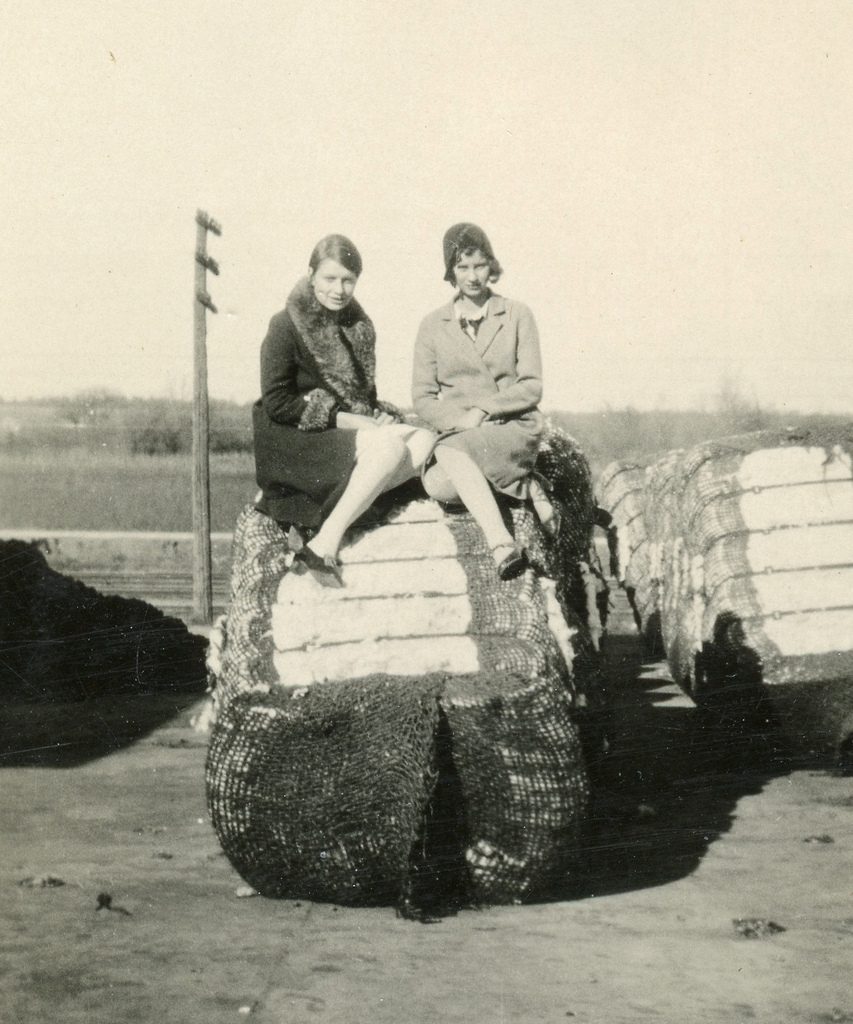 1920s vintage photo of 2 women in 1920s coats posing together on a hat. Great example of fall / winter 1920s fashions. 