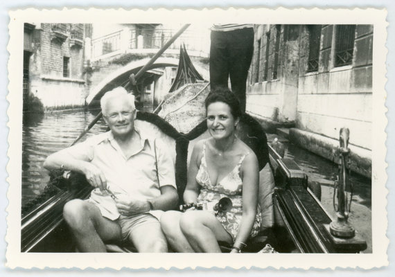 1960s vintage photo of an older couple in a Godola ride in Venice. 
