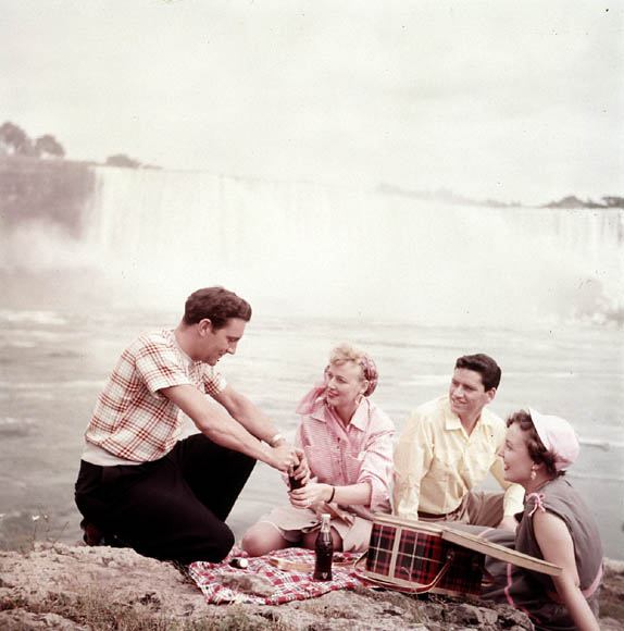1960s vintage picnic image at Niagara Falls featuring two couples in 1960s fashions. 