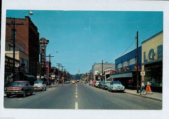 Vintage Postcard Image of Sarnia Ontario, Canada main street in the 1960s. Postcard showcases classic cars