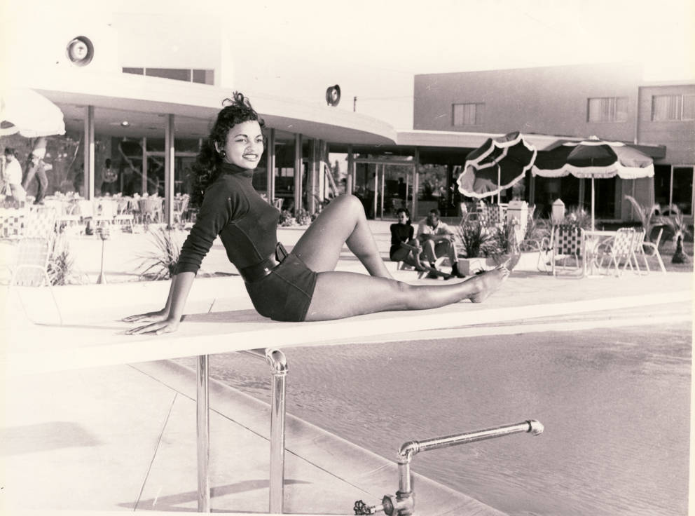 1950s vintage photo: Photograph of a showgirl posed at the swimming pool of Moulin Rouge Hotel and Casino, [May 22], 1955
