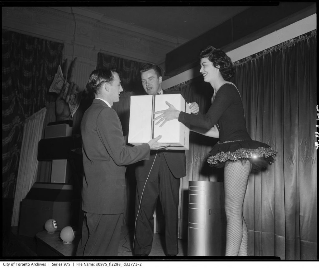 1950's Shell Sales Meeting at the King Edward Hotel with girl in showgirl outfit. 1950s Vintage Photo