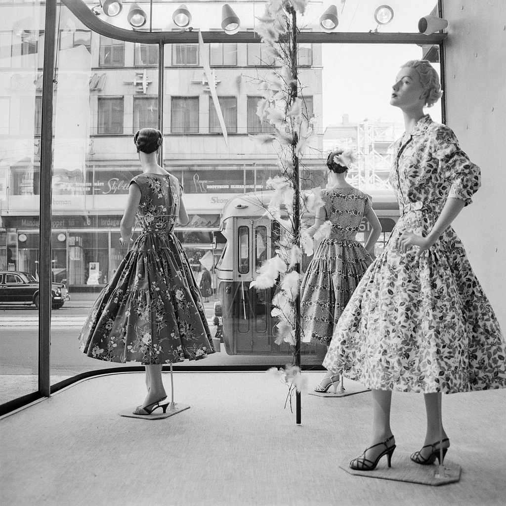 1950s vintage photo of a Storefront at Norrmalmstorg in Stockholm 1957 Vintage Window Display showcasing women's 1950s dresses. 