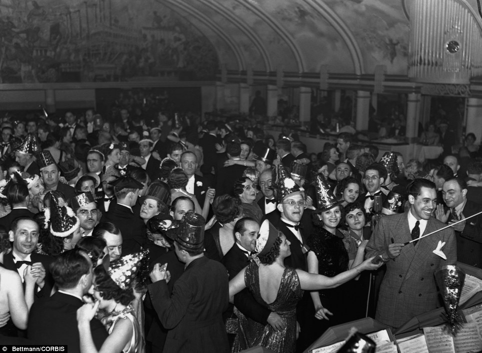 1930s Vintage photo: Party hats at the ready: American bandleader and singer Cab Calloway leads an orchestra during a New Year's Ball at the Cotton Club in New York in 1937