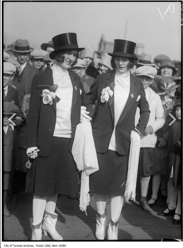 1920s vintage photo of the Toronto Easter Parade at Sunnyside Park featuring two 1920s women in men's suits and top hats. Fun 1920s Fashions! 