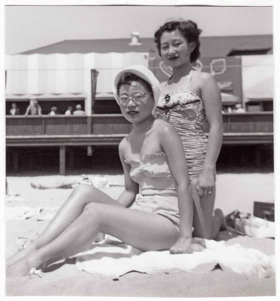 A pair of unidentified young, asian ladies enjoying the beach in the late 1940s Early 1950s. 