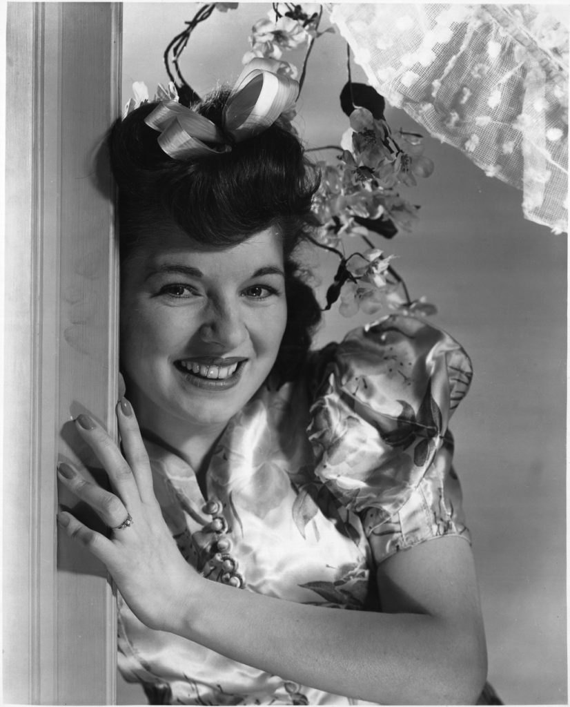 1940s Vintage Photo of a young woman from GECO Munitions factory in 1940s fashion. 