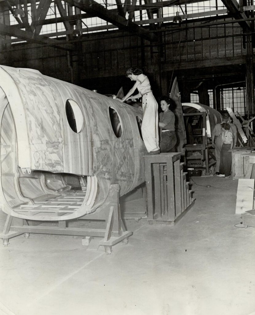 1940s Vintage Photo of Canadian Women during WW2 working on the Final touches to a completed plane fuselage. This was part of the home front effort during the war. 