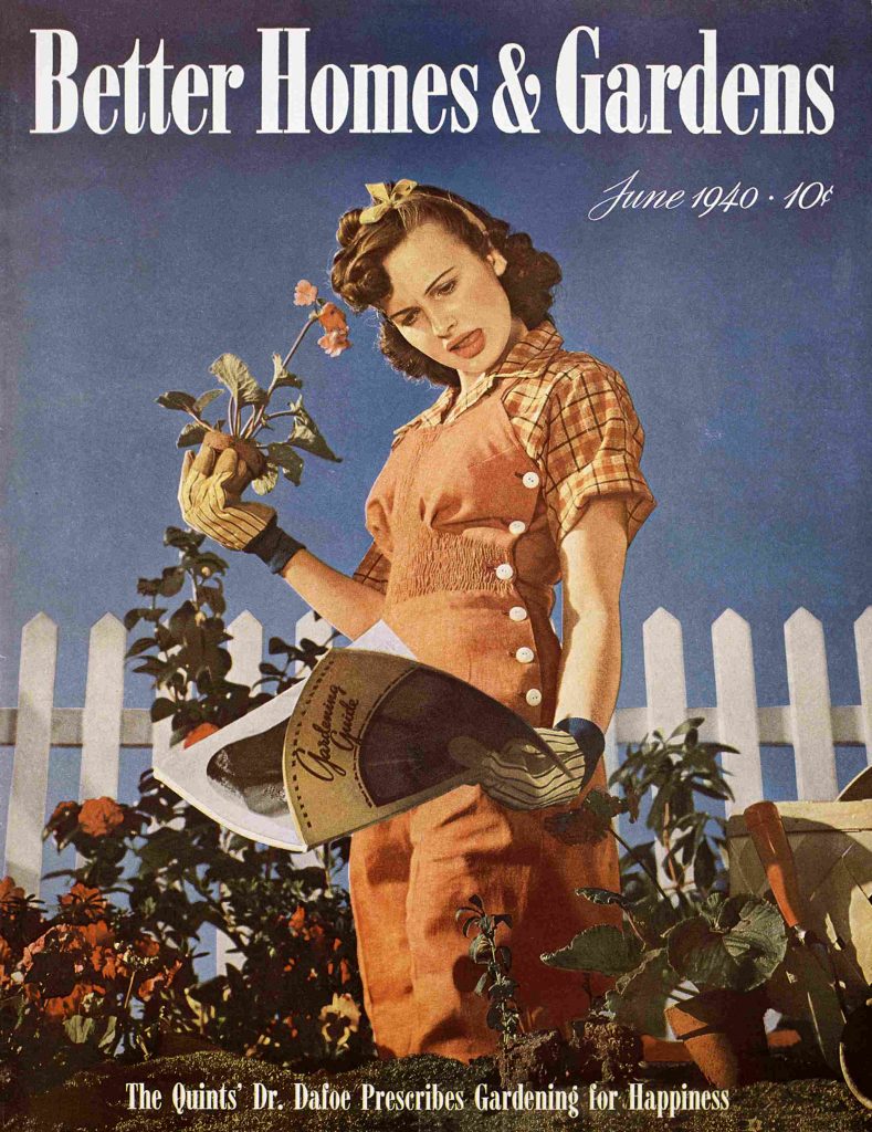 1940s vintage magazine cover from Better Homes & Gardens in June 1940 featuring a woman standing in her garden reading a magazine about how to garden in overalls and 1940s hairstyle. 