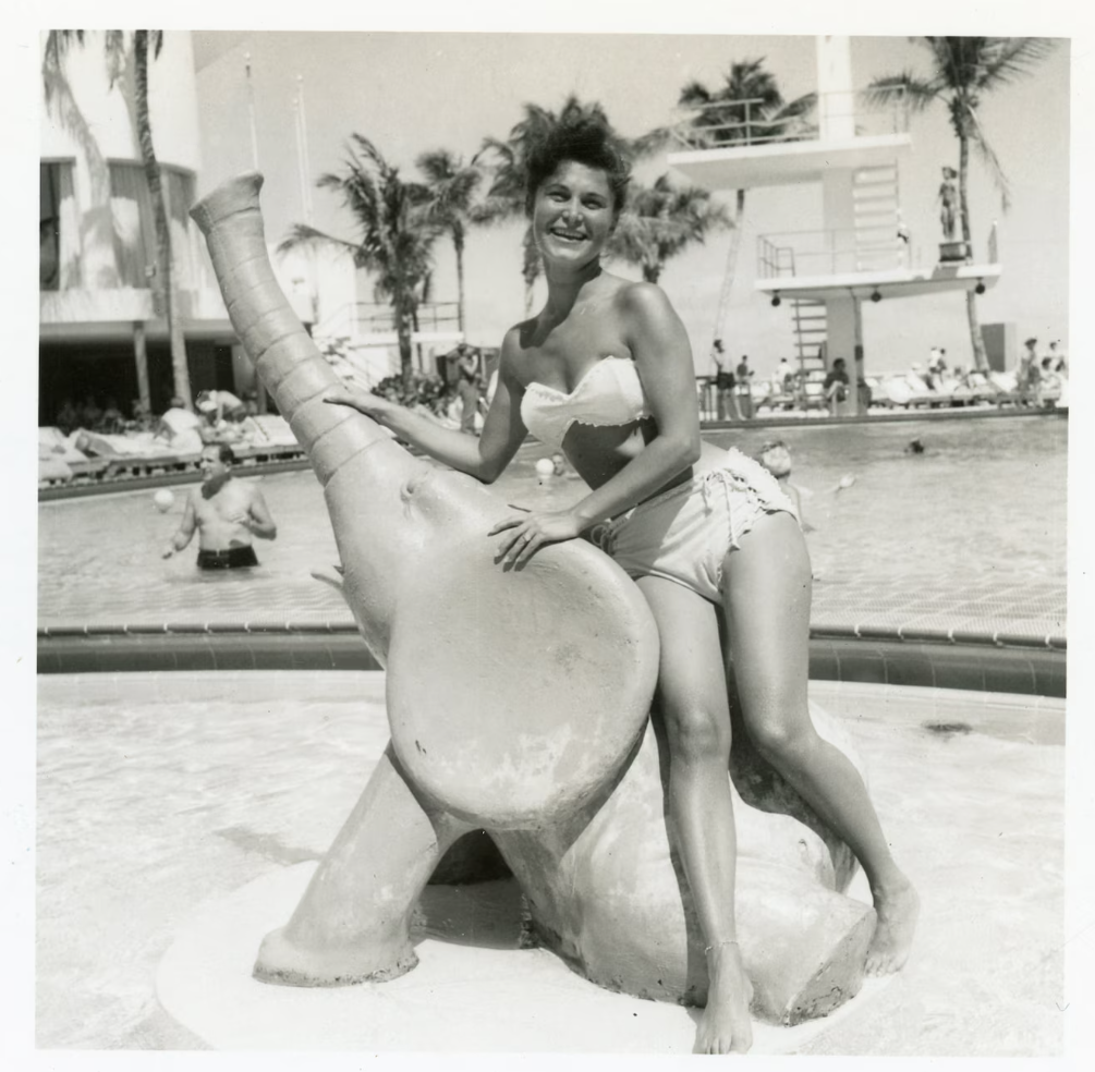 1950s vintage photo of a Woman in Bikini with Elephant Statue in front of the Pool