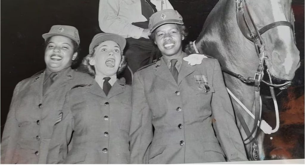 1940s vintage photo of 2 Black Women in the Canadian Army Corps during WW2 posing with another woman in the same uniform and a horse.