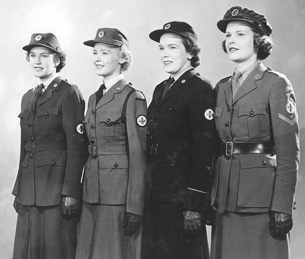 1940s vintage photo: Canadian Red Cross Corps Uniforms. Models show the uniforms worn by all four sections of the Second World War CRCC.