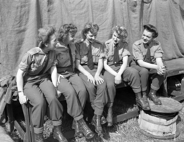 1940s vintage photo of Canadian Woman taking a break to chat during WW2. They are part of the CWAC. In 1941, the Canadian Women's Army Corps was created, paving the way for a long tradition of Canadian women in the military 