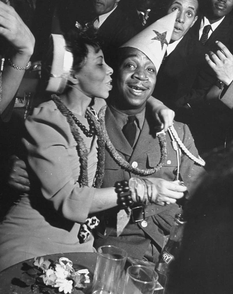 1940s Vintage Photo: A Black Soldier & Black Woman celebrating the New Year in a nightclub, 1942.