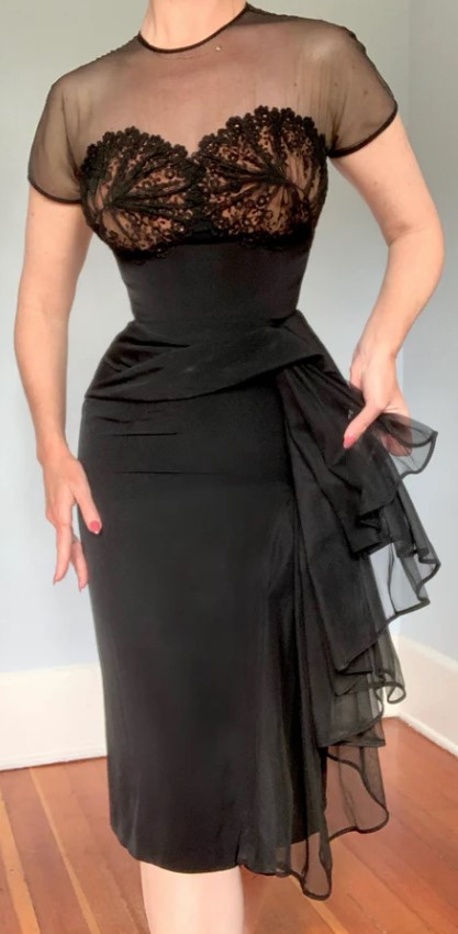 1940s / 1950s vintage black cocktail dress from Dorothy O'Hara featuring a black shear illusion bust and side hip swag (sash). Stunning 1940s Fashion or 1950s fashion (Unsure).