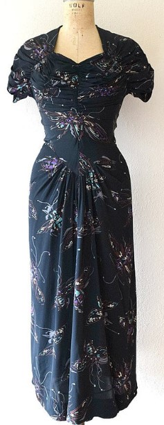 1940s Fashion: 1940s rayon dress with the Dorothy O'Hara signature draping throughout, giving the dress a fantastic silhouette. The novelty print is a flying bug print (bug unknown).