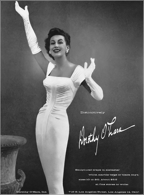 1950s fashion / 1950s Advertising: 1950s Model in alabaster crêpe sheath dress by Dorothy O'Hara, Vogue, March 1, 1957