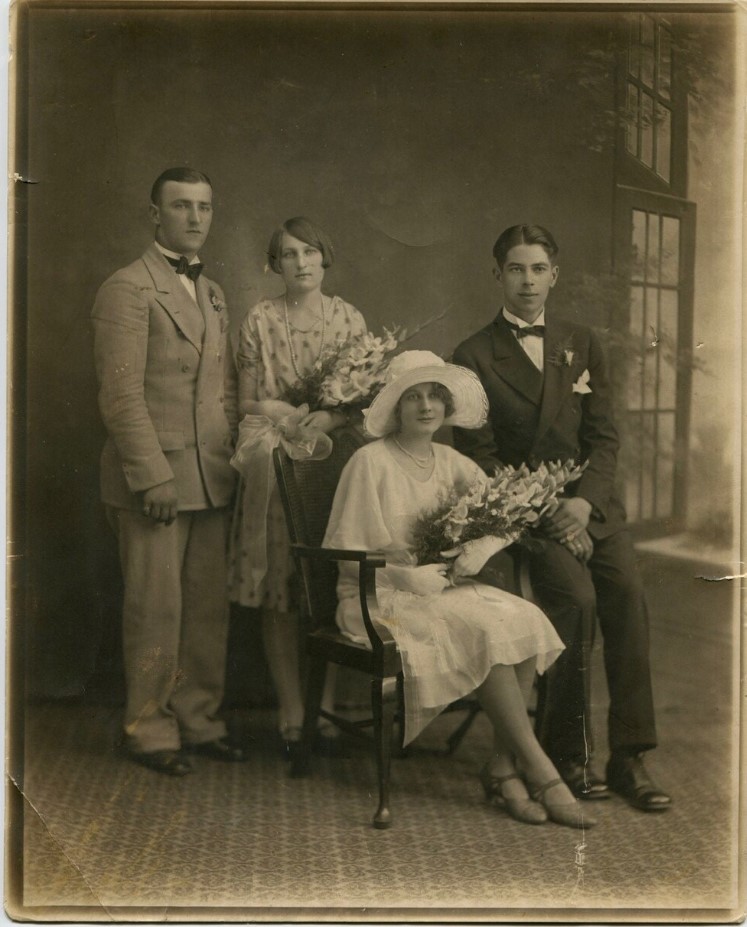 1920s vintage wedding photo of a bride and groom posing with their witnesses in their 1920s wedding fashions. 