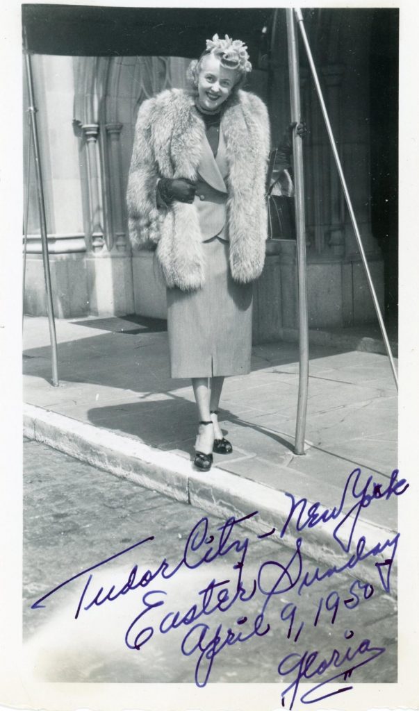 1950s vintage photo from 1950 of a woman name Gloria in a two piece suit and fur wrap, a floral hat and open toe shoes in Tudor City, New York on Easter Sunday. Fantastic early 1950s fashion. 