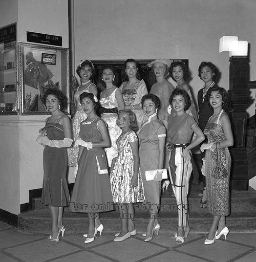 1950s vintage photo: Raffles Hotel fashion parade-1958 in Singapore. The women are in 1950s fashions like, 1950s dresses and pants and tops. There is even a young girl in the middle. 