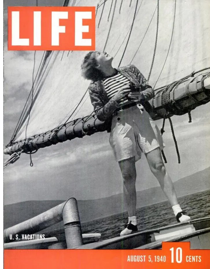 1940s vintage magazine cover: August 5, 1940 LIFE Magazine cover "U.S. Vacations" (photo by George Karger) featuring a woman on a sailboat, sailing. Vintage summer fun. 