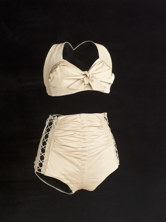 1940s Fashion: The Cole of California Swimsuit from 1943 called the Swoon Suit. Designed by Margit Fellegi. A two-piece suit that used side-laces to compensate for the lack of rubber