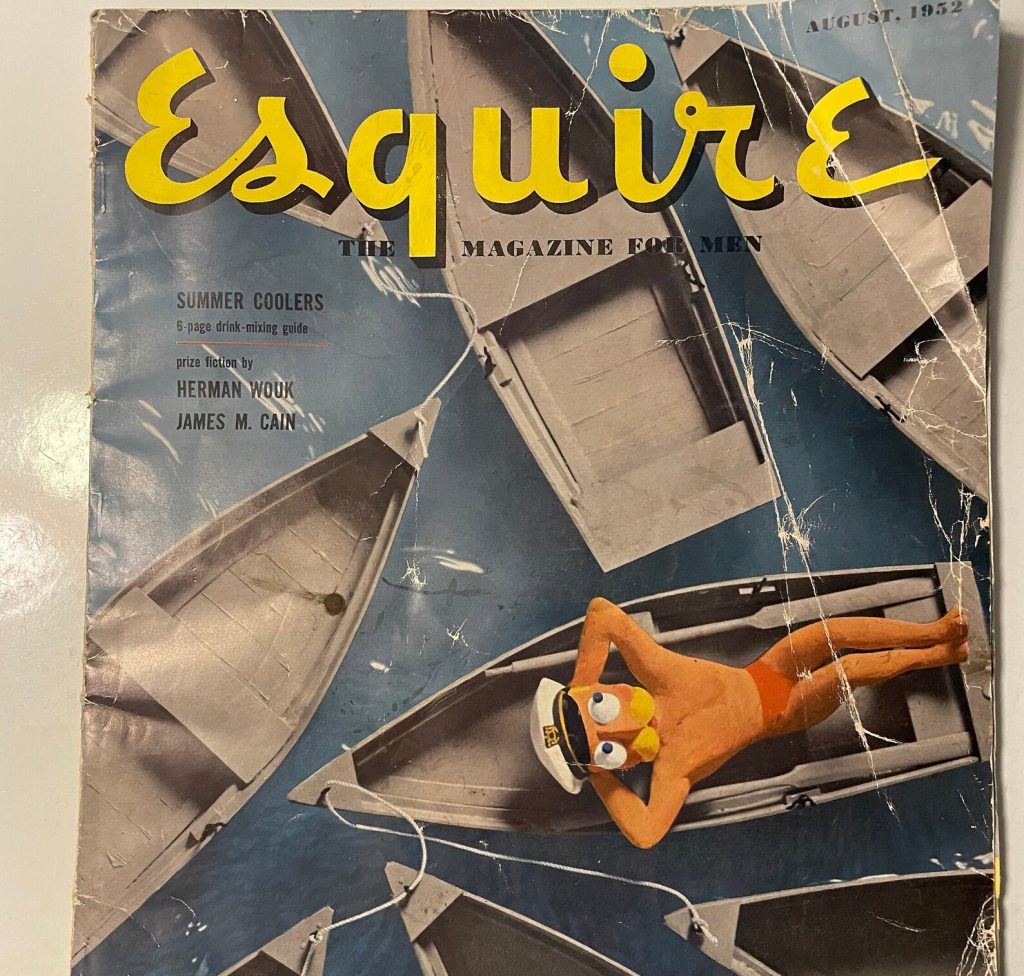 1950s vintage magazine cover-August 1952 image from Esquire Magazine for Men featuring a clay man laying on a small boat surrounded by other small boats. Vintage Summer Fun. 