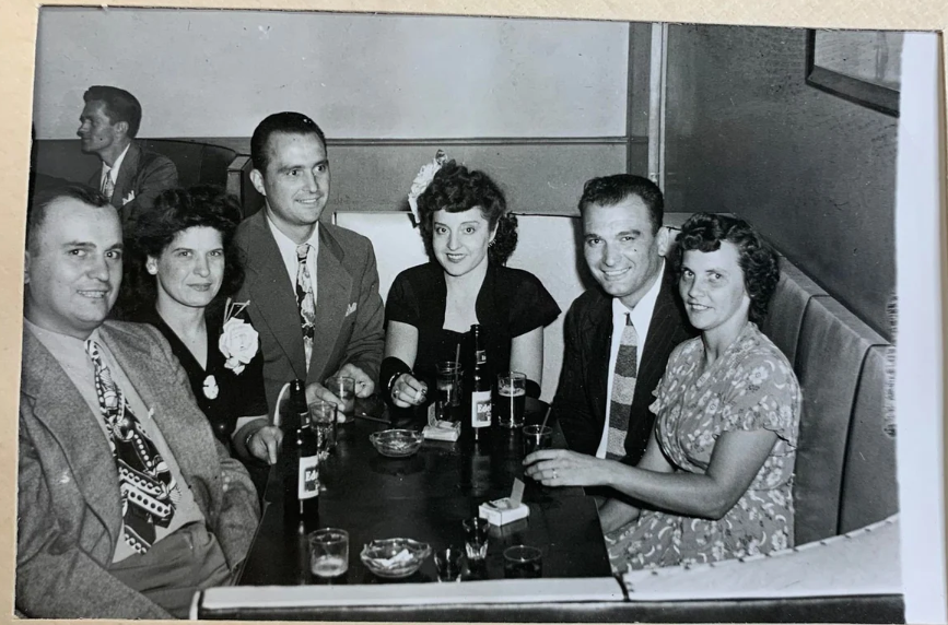 1940s vintage photo from a souvenir card from the 'The Ringside" across from Madison Square Garden featuring couples out for drinks in 1940s fashions and 1940s hairstyles. Great 1940s ties on the men. 